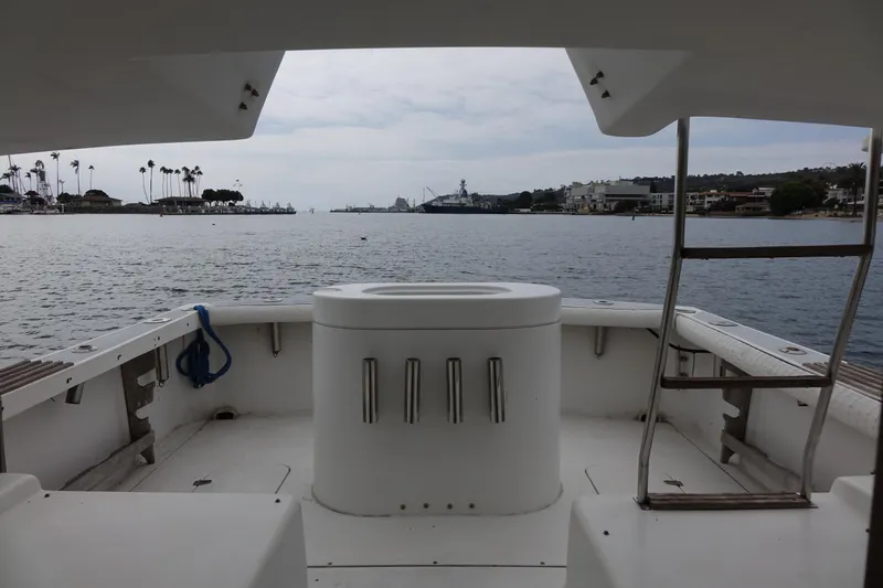 Slide: The Image of 1988 Blackfin 29 Flybridge boat interior with ocean view, featuring a central console and ladder. - 39