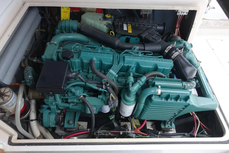 Slide: The Image of Engine compartment of a 1988 Blackfin 29 Flybridge boat, showcasing detailed mechanical components. - 41