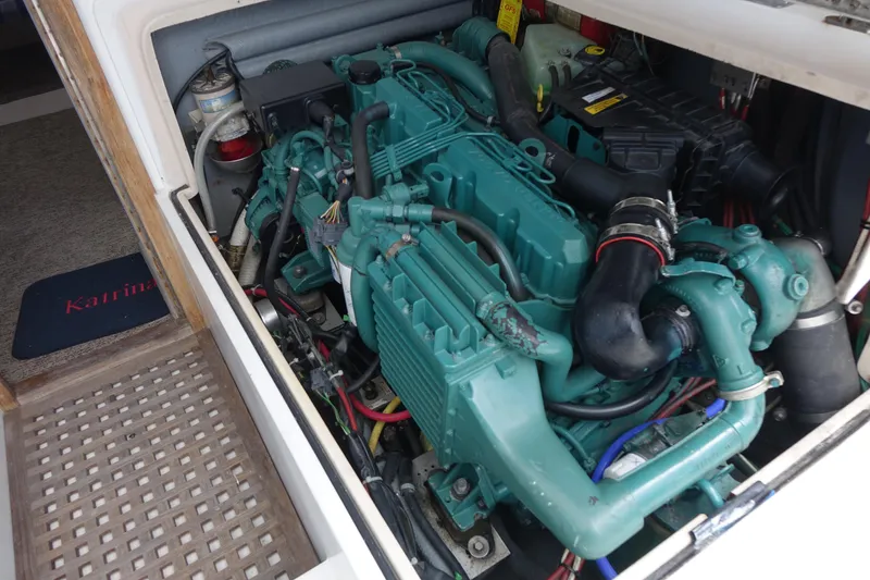 Slide: The Image of Engine compartment of a 1988 Blackfin 29 Flybridge boat, showcasing detailed mechanical components. - 43