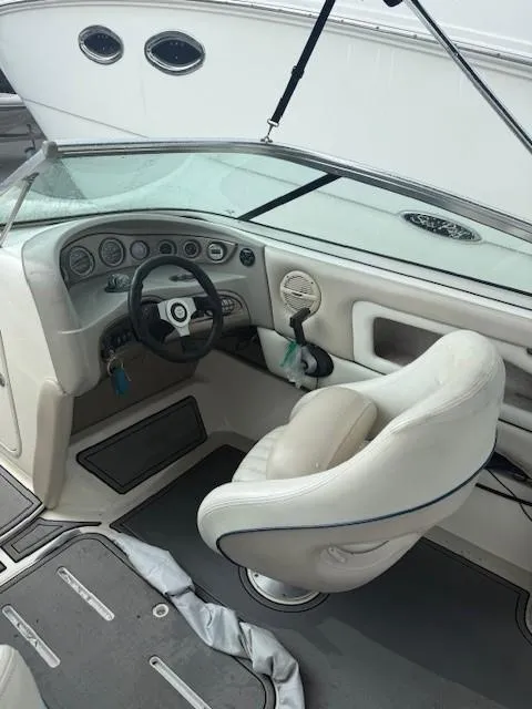 Slide: The Image of Interior of a 2006 Bryant 219 boat showing steering wheel and dashboard. - 11