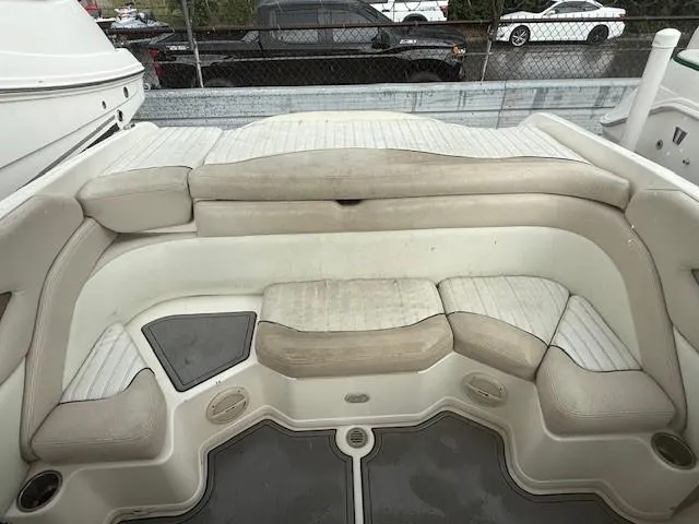 Slide: The Image of 2006 Bryant 219 boat interior with beige seating and storage compartments. - 13