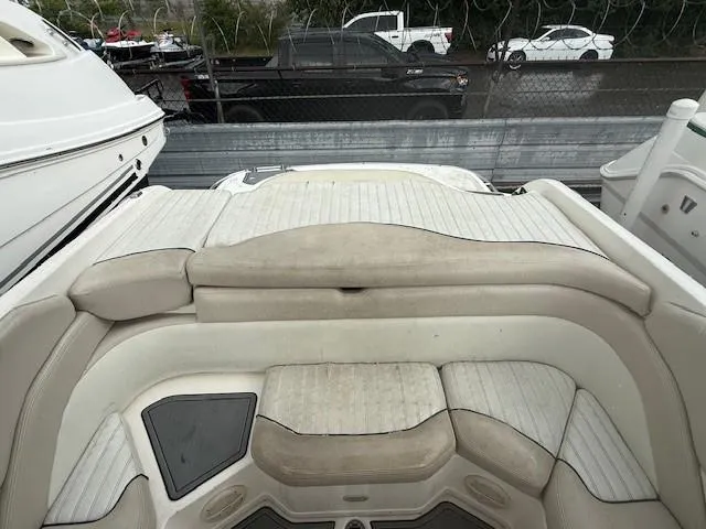 Slide: The Image of 2006 Bryant 219 boat interior with beige seating and storage compartments. - 14
