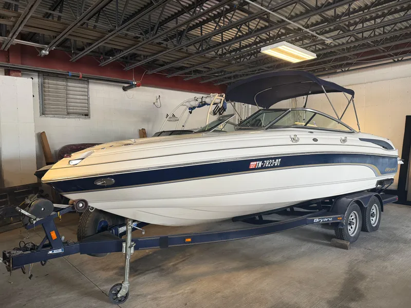 Slide: The Image of 2006 Bryant 219 boat on trailer in a garage setting. - 2