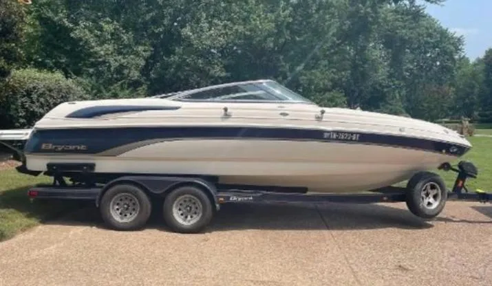 Slide: The Image of 2006 Bryant 219 boat on trailer, parked outdoors on a sunny day. - 5