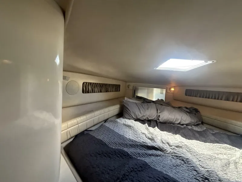 Slide: The Image of Cozy cabin interior of 1996 Sea Ray 500 Sundancer with bed and skylight. - 11