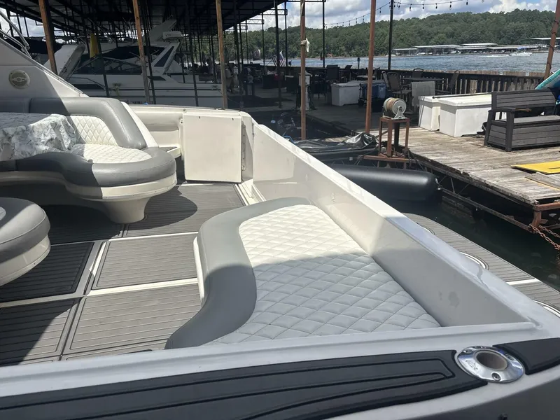 Slide: The Image of 1996 Sea Ray 500 Sundancer yacht interior with cushioned seating at a marina dock. - 17