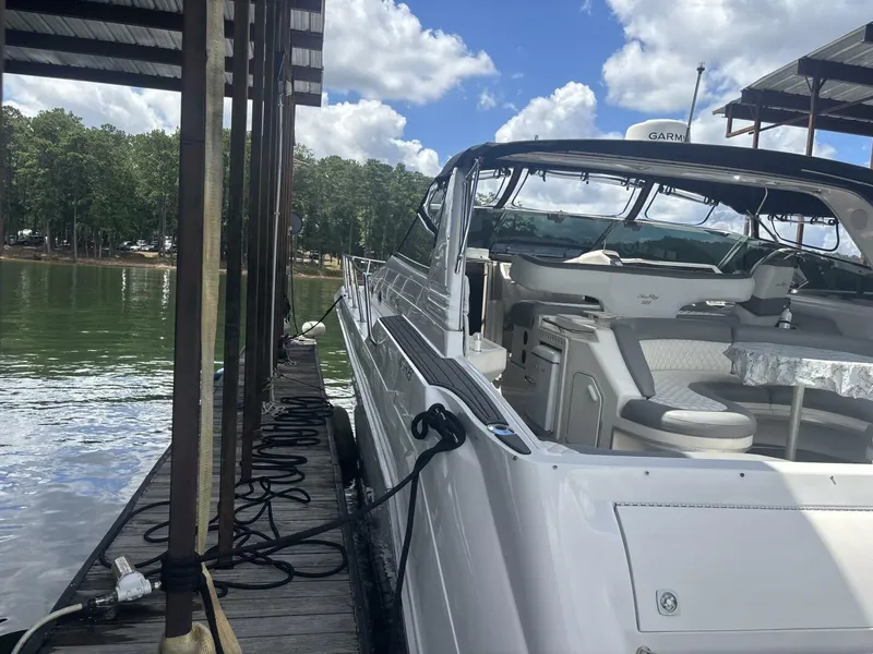 Slide: The Image of Sea Ray 500 Sundancer 1996 docked, featuring spacious seating and clear skies. - 20