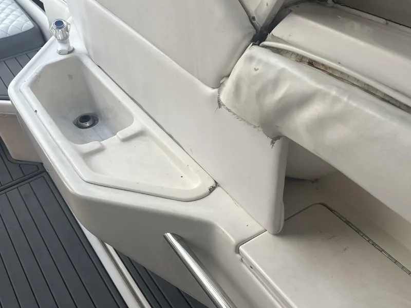 Slide: The Image of 1996 Sea Ray 500 Sundancer boat interior with sink and seating area. - 24