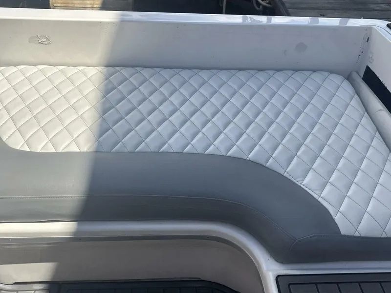 Slide: The Image of Quilted seating on 1996 Sea Ray 500 Sundancer boat, featuring elegant white and gray upholstery. - 25