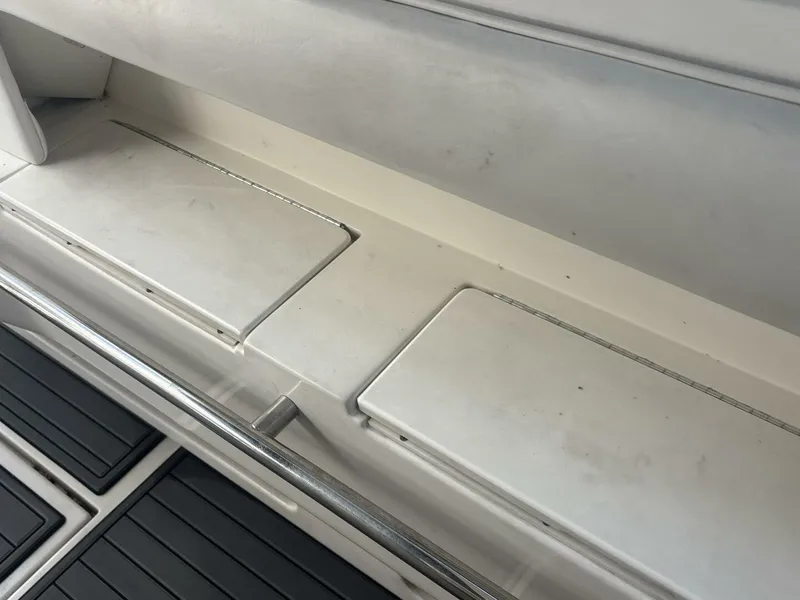 Slide: The Image of Interior view of a 1996 Sea Ray 500 Sundancer boat, featuring storage compartments. - 29