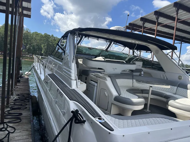 Slide: The Image of 1996 Sea Ray 500 Sundancer yacht docked, featuring spacious seating and sleek design. - 3