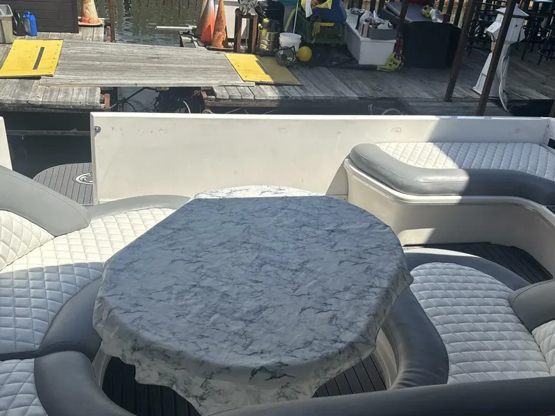 Slide: The Image of 1996 Sea Ray 500 Sundancer yacht interior with cushioned seating and a covered table. - 30