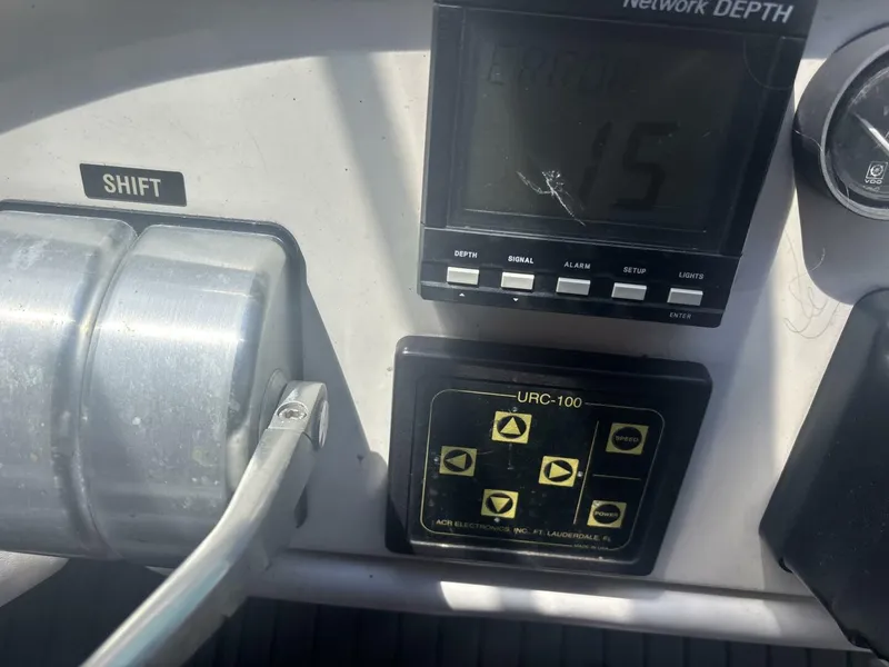 Slide: The Image of Control panel of a 1996 Sea Ray 500 Sundancer boat with depth gauge and shift lever. - 39
