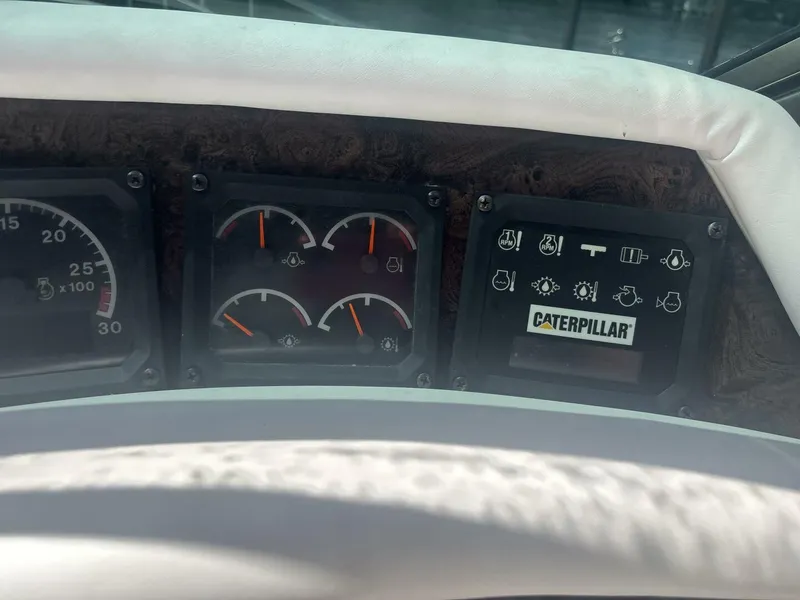 Slide: The Image of Dashboard of a 1996 Sea Ray 500 Sundancer with Caterpillar engine gauges. - 47