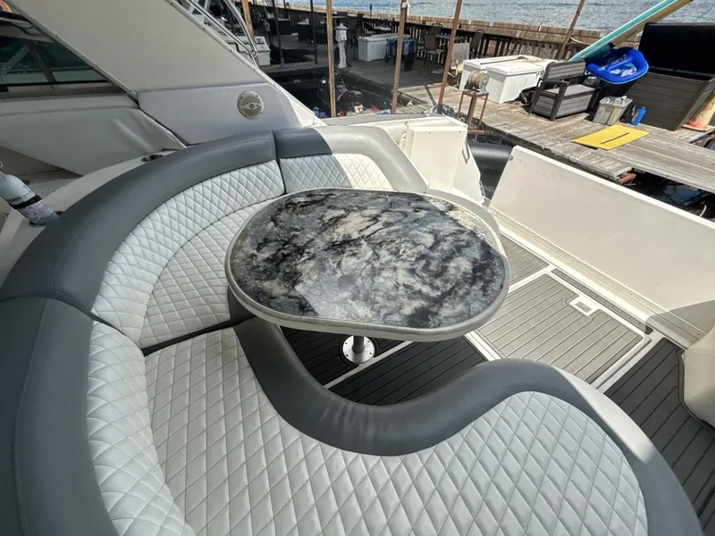 Slide: The Image of Luxurious seating area on a 1996 Sea Ray 500 Sundancer yacht with a marble table. - 6