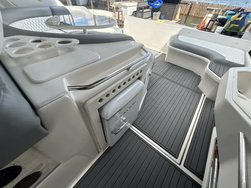 Slide: The Image of 1996 Sea Ray 500 Sundancer interior with seating, table, and storage compartments. - 7