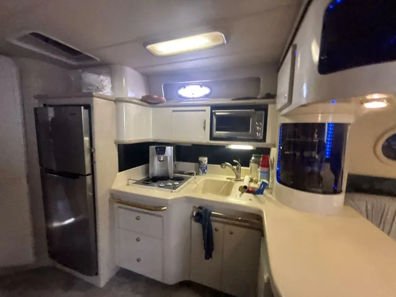 Slide: The Image of Interior of 1996 Sea Ray 500 Sundancer yacht kitchen with modern appliances and sleek design. - 8