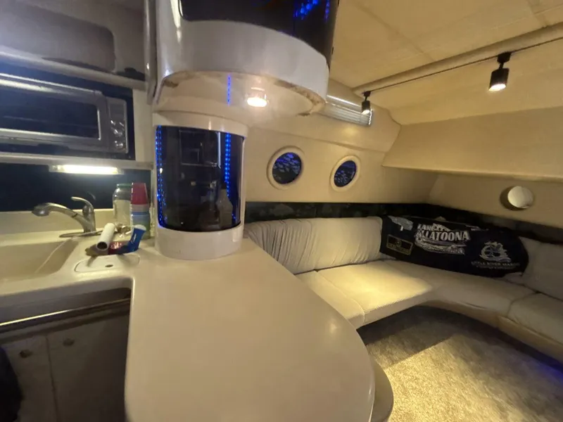 Slide: The Image of Interior of 1996 Sea Ray 500 Sundancer yacht with kitchenette and seating area. - 9