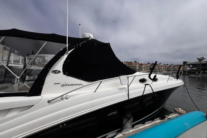Slide: The Image of 2007 Sea Ray 340 Sundancer boat docked at marina with black canopy. - 13