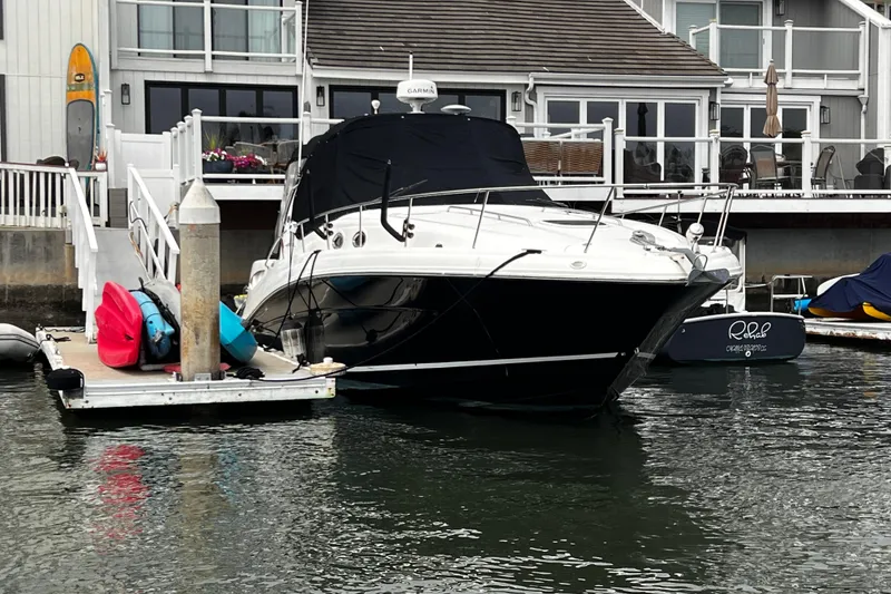 Slide: The Image of 2007 Sea Ray 340 boat docked near waterfront home with kayaks and paddleboards. - 15