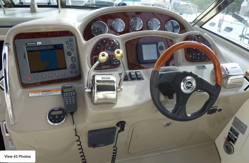 Slide: The Image of 2007 Sea Ray 340 helm with navigation system, gauges, and steering wheel. - 5