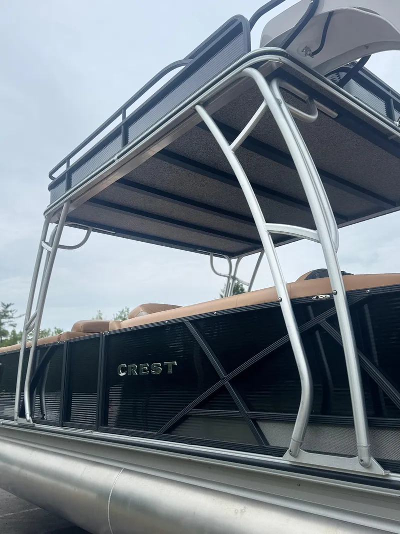 Slide: The Image of 2025 Crest Caribbean LX 250 pontoon boat with sleek design and sturdy frame. - 3