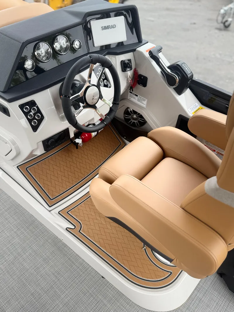 Slide: The Image of 2025 Crest Caribbean LX 250 boat cockpit with tan seating and modern dashboard controls. - 6