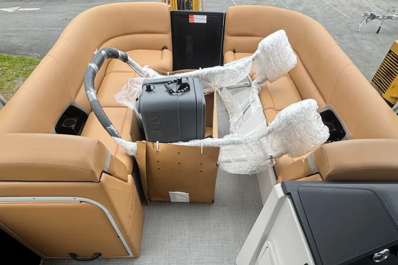 Slide: The Image of 2025 Crest Caribbean LX 250 boat interior with tan seating and wrapped components. - 7
