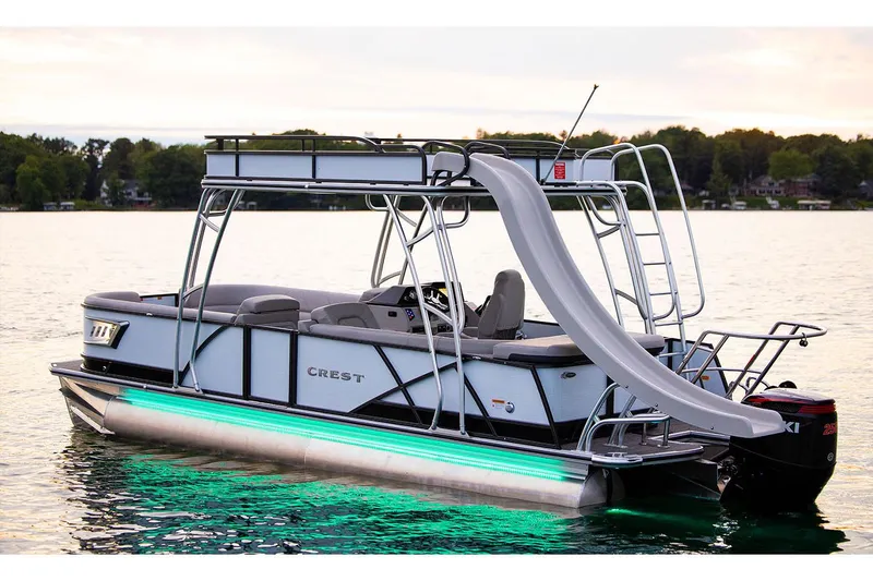 Slide: The Image of Manufacturer Provided Image: 2024 Crest Caribbean LX 250 pontoon boat with slide on a serene lake. - 8