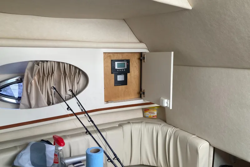 Slide: The Image of Interior of 2000 Sea Ray 290 Amberjack with fishing rods and storage cabinet. - 10