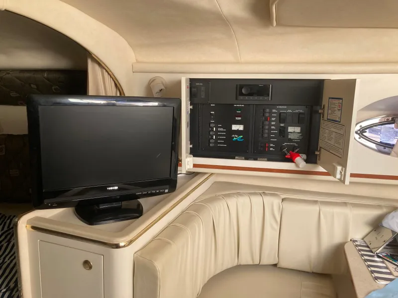 Slide: The Image of Interior of 2000 Sea Ray 290 Amberjack with TV and control panel. - 3