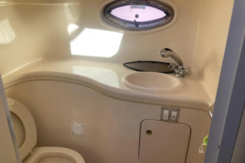 Slide: The Image of Compact bathroom in 2000 Sea Ray 290 Amberjack boat with sink and toilet. - 6