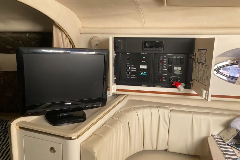 Slide: The Image of Interior of 2000 Sea Ray 290 Amberjack with TV and control panel. - 9
