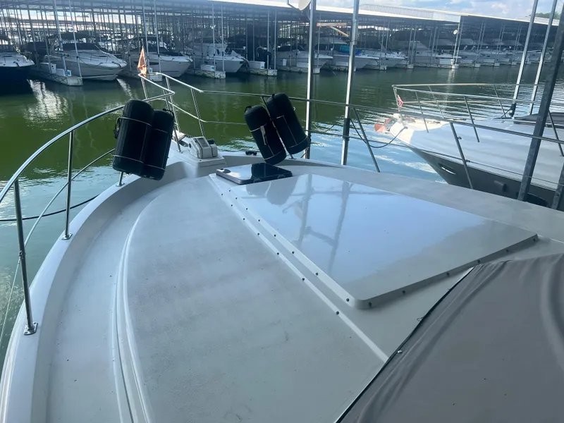 Slide: The Image of 1987 Carver 420 Cockpit Motor Yacht docked in a marina. - 13