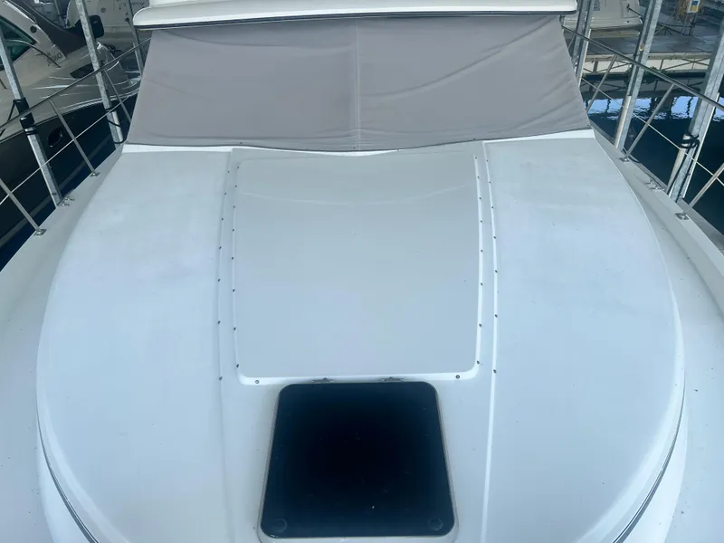Slide: The Image of 1987 Carver 420 Cockpit Motor Yacht deck with hatch and cover, docked in marina. - 14