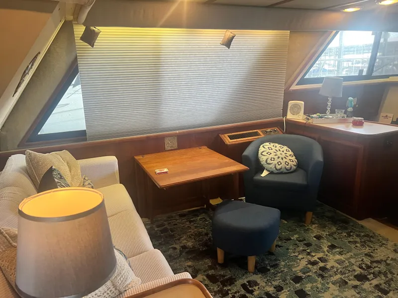 Slide: The Image of Interior of 1987 Carver 420 Cockpit Motor Yacht with cozy seating and wooden table. - 16