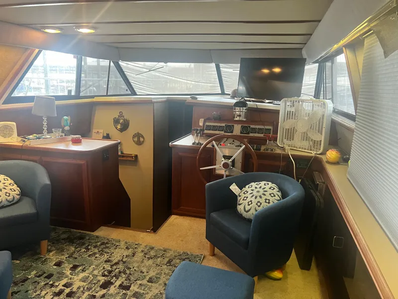 Slide: The Image of 1987 Carver 420 Cockpit Motor Yacht interior with helm, seating, and decor. - 17