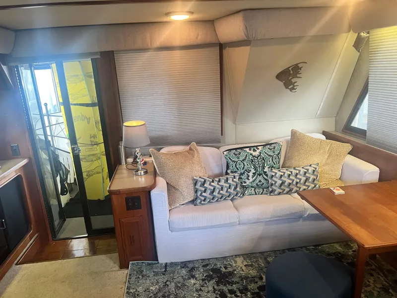 Slide: The Image of Interior of 1987 Carver 420 Cockpit Motor Yacht with cozy seating and decor. - 18