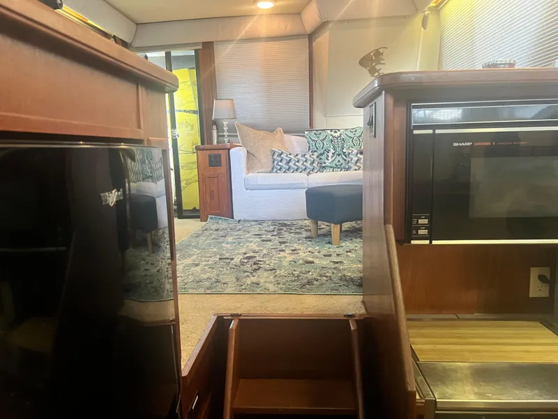 Slide: The Image of Interior of 1987 Carver 420 Cockpit Motor Yacht with cozy seating and modern appliances. - 22