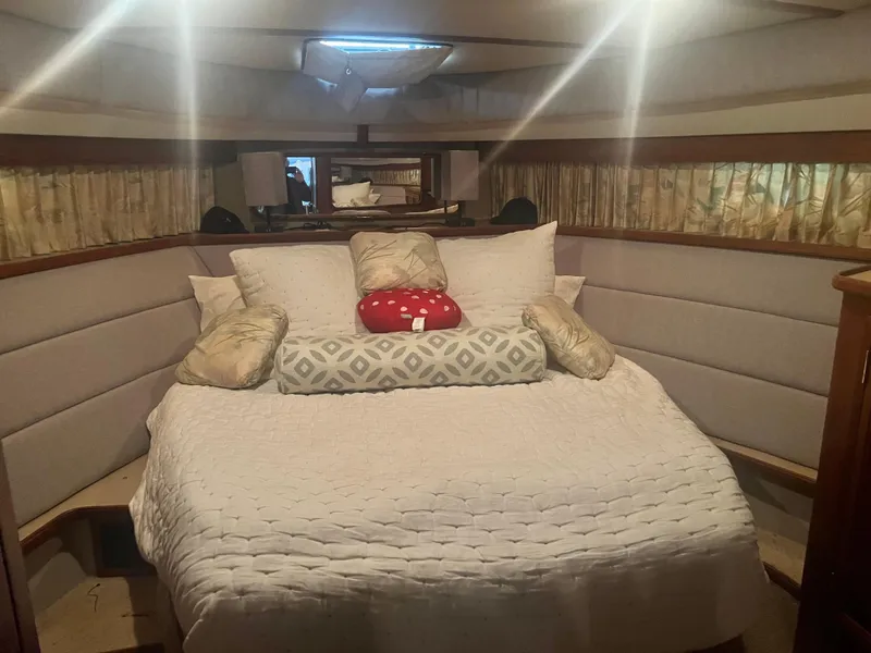 Slide: The Image of Cozy bedroom interior of 1987 Carver 420 Cockpit Motor Yacht with plush bedding. - 23