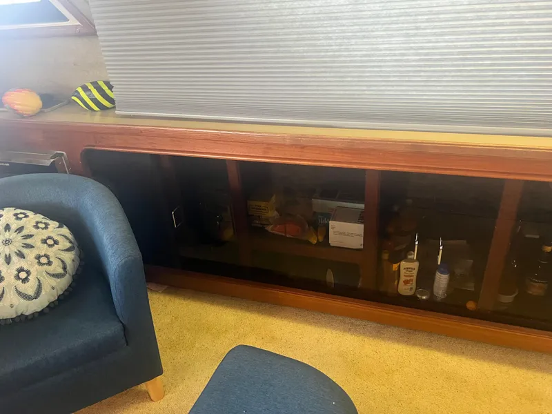 Slide: The Image of Interior of 1987 Carver 420 Cockpit Motor Yacht with seating and storage cabinet. - 30