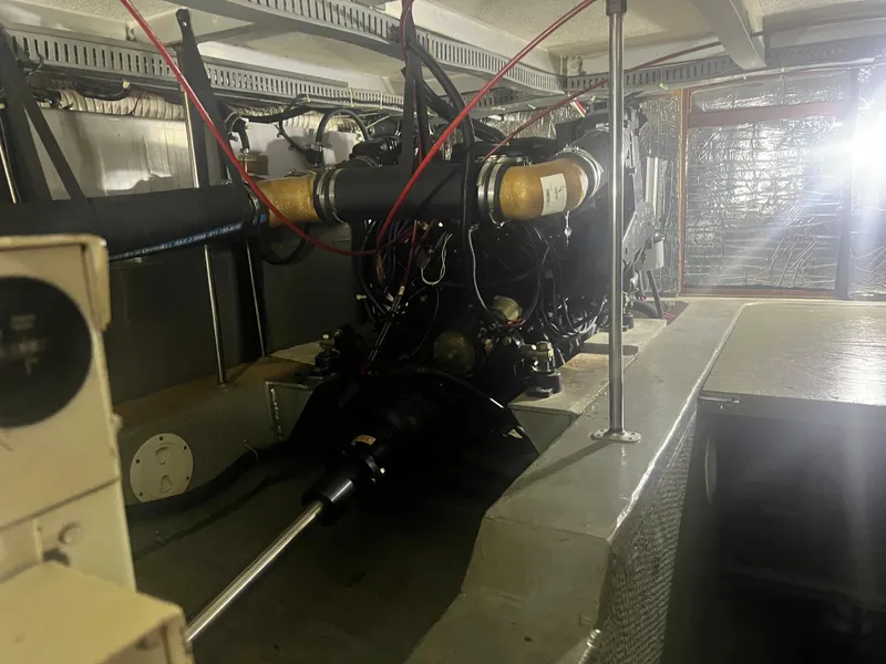 Slide: The Image of Engine room of a 1987 Carver 420 Cockpit Motor Yacht, showcasing mechanical components. - 33