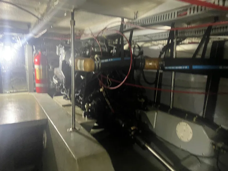 Slide: The Image of Engine room of 1987 Carver 420 Cockpit Motor Yacht with visible fire extinguisher. - 34