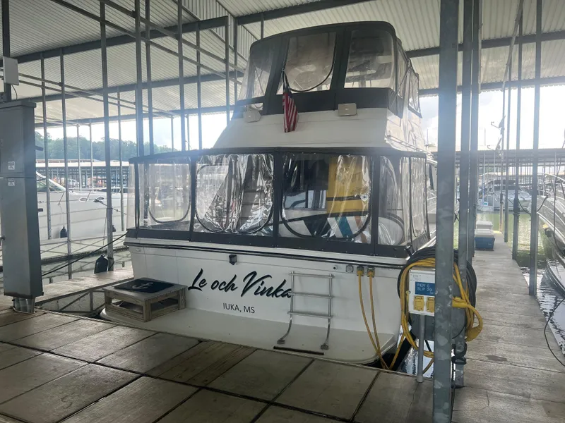 Slide: The Image of 1987 Carver 420 Cockpit Motor Yacht docked in marina, rear view. - 4