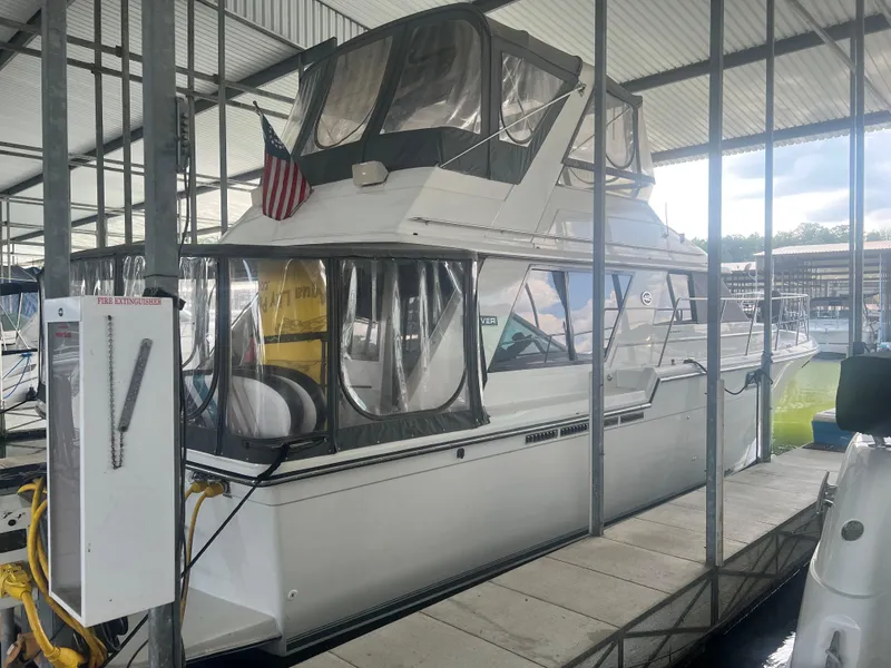 Slide: The Image of 1987 Carver 420 Cockpit Motor Yacht docked in a covered marina. - 5