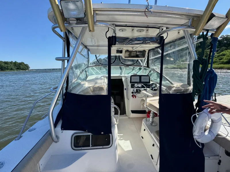 Slide: The Image of 1999 Boston Whaler 28 Conquest boat interior with navigation equipment on a sunny day. - 21