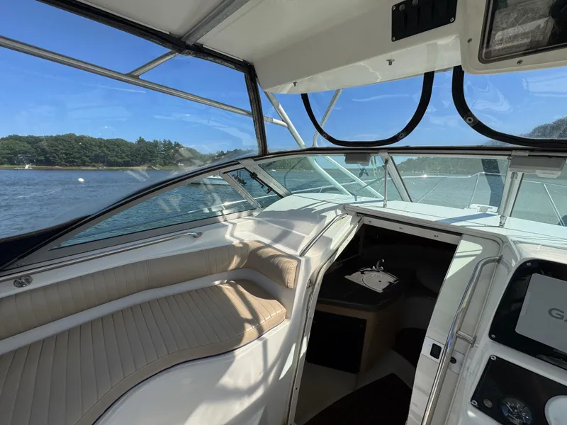 Slide: The Image of Interior view of a 1999 Boston Whaler 28 Conquest boat with scenic water backdrop. - 23
