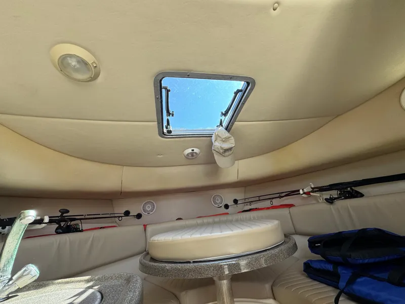Slide: The Image of Interior of 1999 Boston Whaler 28 Conquest boat with fishing rods and seating area. - 34