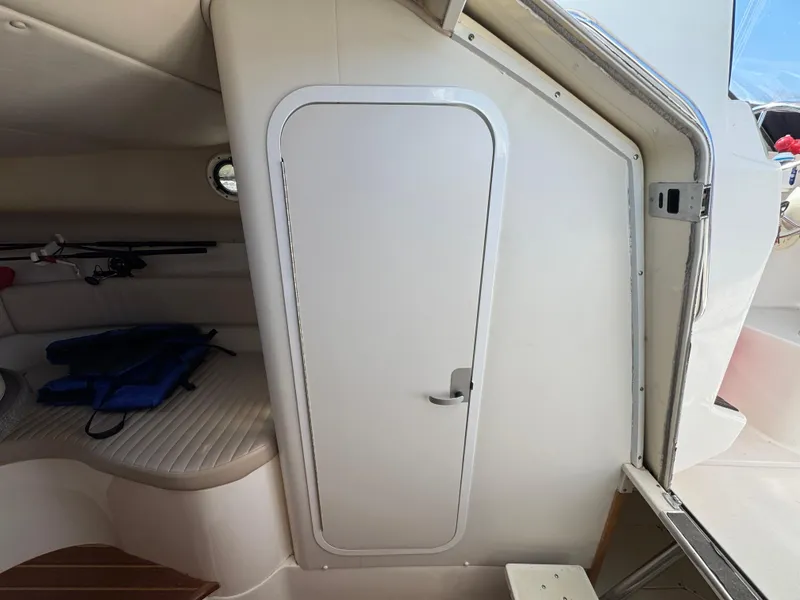 Slide: The Image of Interior cabin of a 1999 Boston Whaler 28 Conquest boat, featuring a closed door. - 35