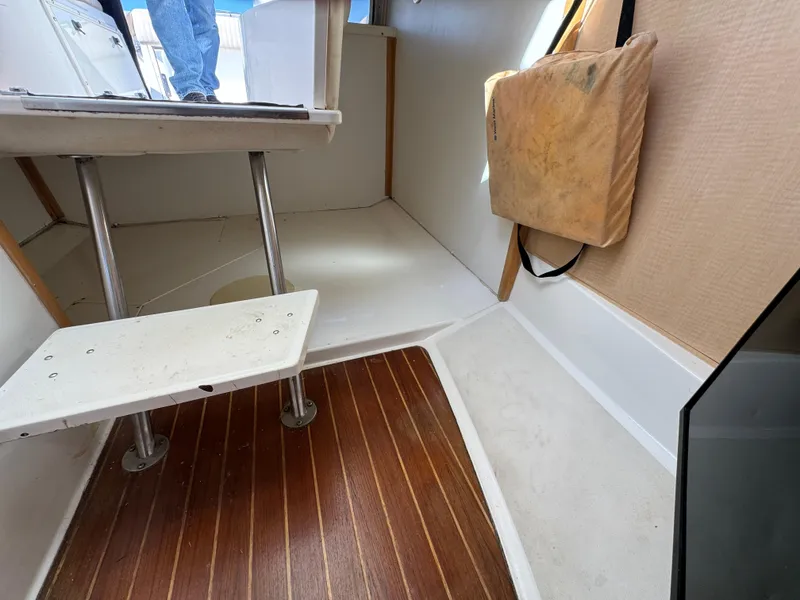 Slide: The Image of Interior of 1999 Boston Whaler 28 Conquest with wooden flooring and steps. - 37